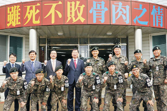 23일 1사단을 방문한 박진수 LG화학 부회장(두번째줄 왼쪽 네번째)이 1사단장 이종화 소장(다섯번째)을 비롯한 장병들과 함께 파이팅을 외치고 있다.  LG 제공